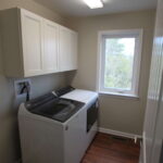 Teal Bliss Waterfront newly constructed home in Swann Keys laundry room